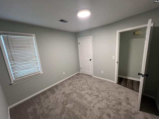unfurnished bedroom with carpet and baseboards