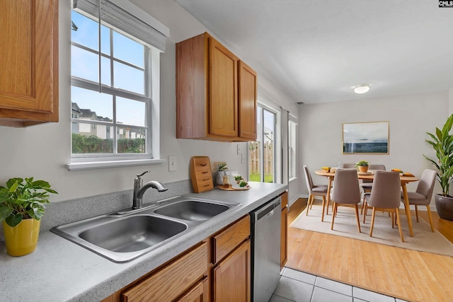 127 Curvewood Rd, Columbia, SC 29229 - kitchen featuring dishwasher, a sink, healthy amount of natural light, and brown cabinets