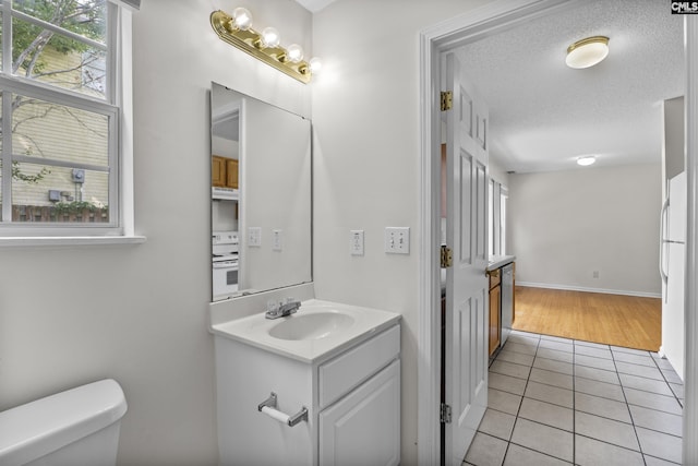 127 Curvewood Rd, Columbia, SC 29229 - half bathroom featuring tile patterned floors, toilet, vanity, and healthy amount of natural light