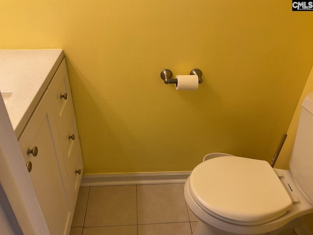 bathroom with tile patterned flooring, toilet, vanity, and baseboards