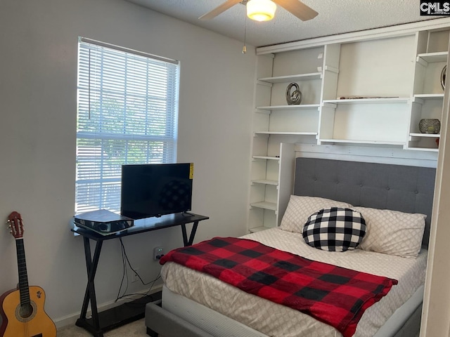 carpeted bedroom featuring multiple windows and ceiling fan