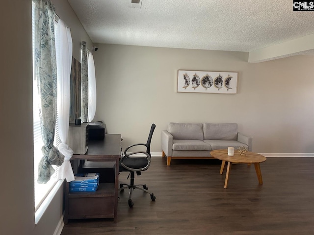 office featuring a textured ceiling, wood finished floors, and baseboards
