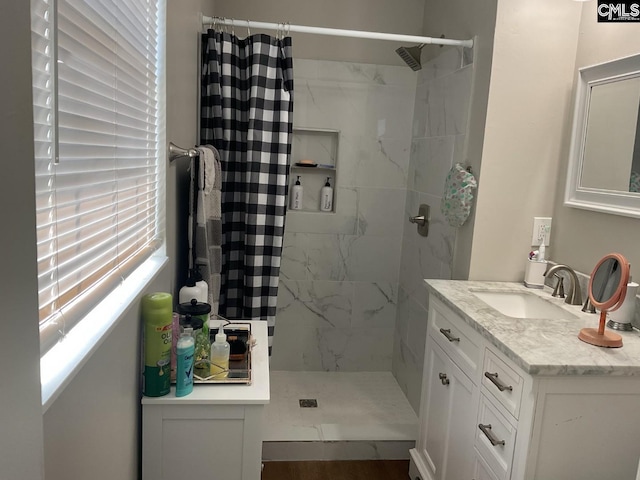 bathroom with a stall shower and vanity