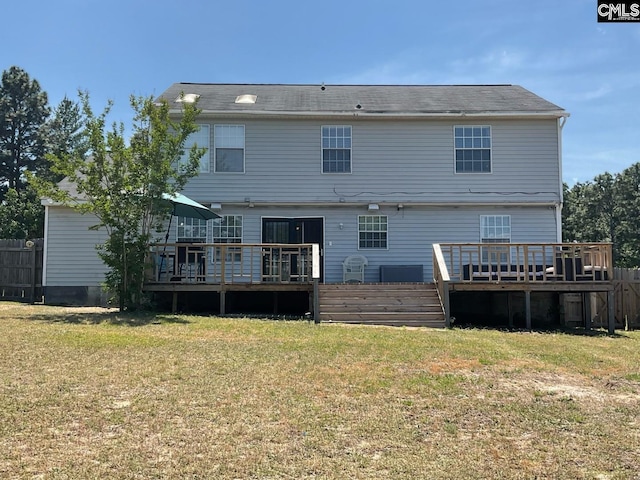 rear view of property featuring a wooden deck