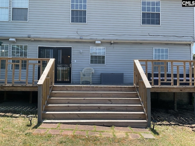 rear view of house with stairs and a deck