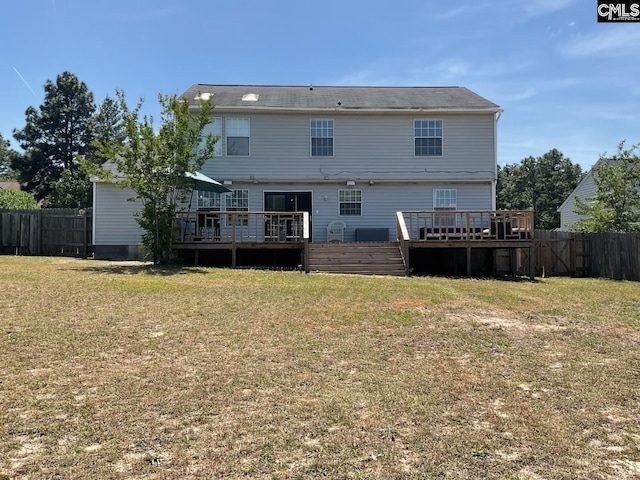 rear view of house featuring a wooden deck