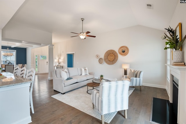 living room featuring a ceiling fan, lofted ceiling, dark wood-style floors, ornate columns, and baseboards