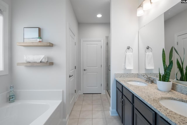 bathroom with tile patterned floors, a garden tub, a shower stall, double vanity, and recessed lighting