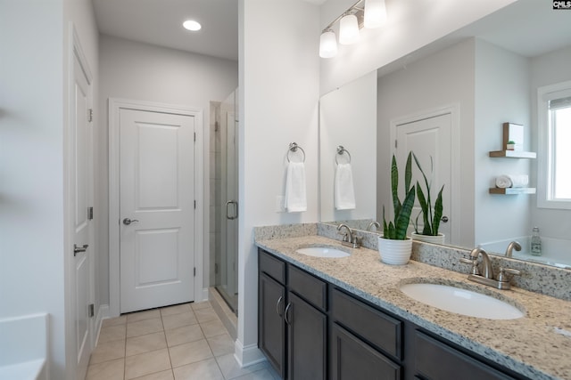 full bathroom featuring tile patterned flooring, a shower stall, and double vanity
