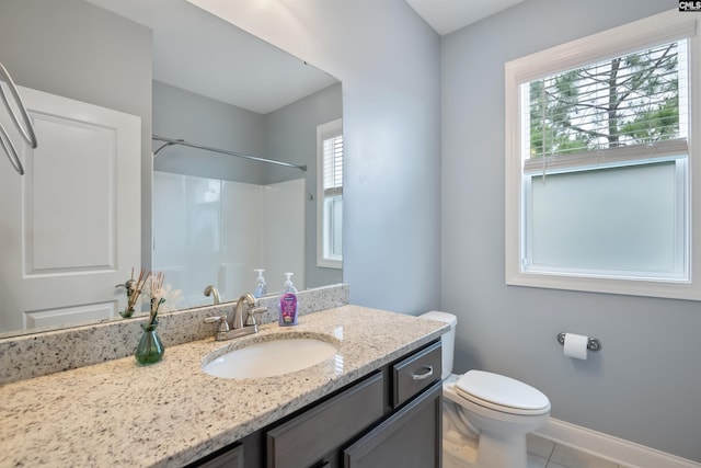full bathroom with toilet, vanity, tile patterned flooring, baseboards, and a shower