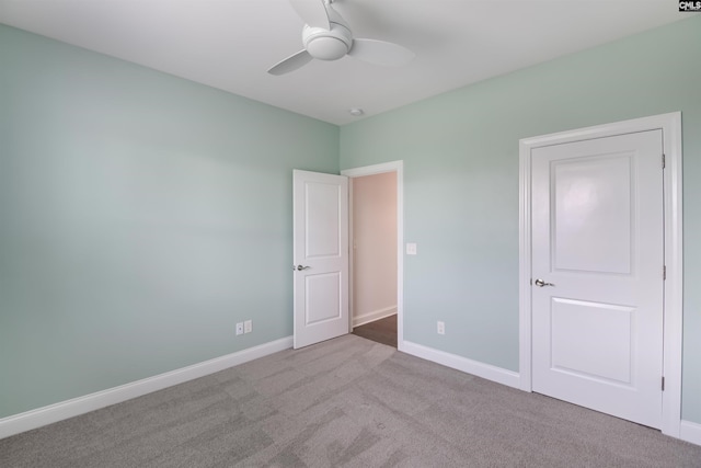 unfurnished bedroom with carpet floors, baseboards, and a ceiling fan
