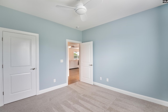 unfurnished bedroom featuring carpet flooring, baseboards, and ceiling fan