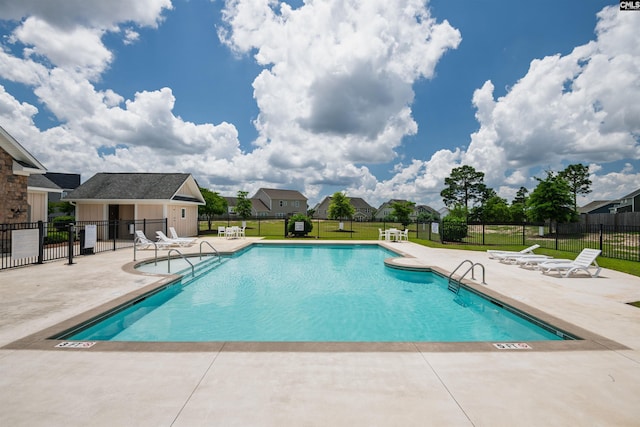 community pool featuring a patio area and a residential view
