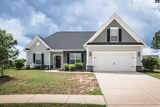 craftsman-style house with stone siding, a front lawn, driveway, and an attached garage