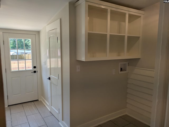 laundry area with washer hookup, baseboards, and light tile patterned flooring