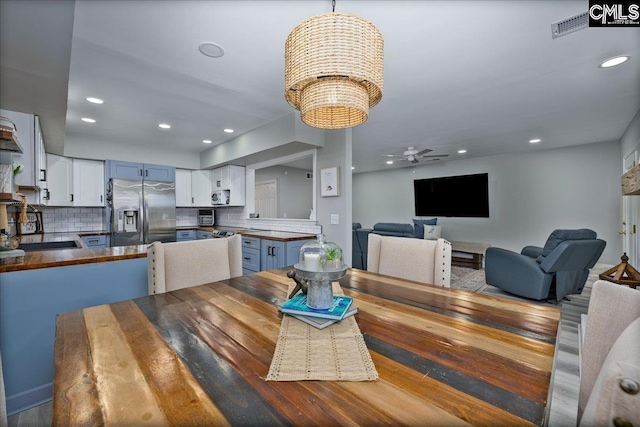 dining space with a chandelier, recessed lighting, and a ceiling fan