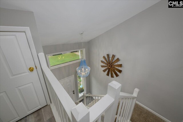 stairs with baseboards and a chandelier