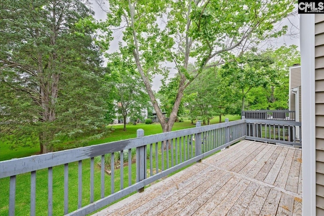 wooden terrace with a yard