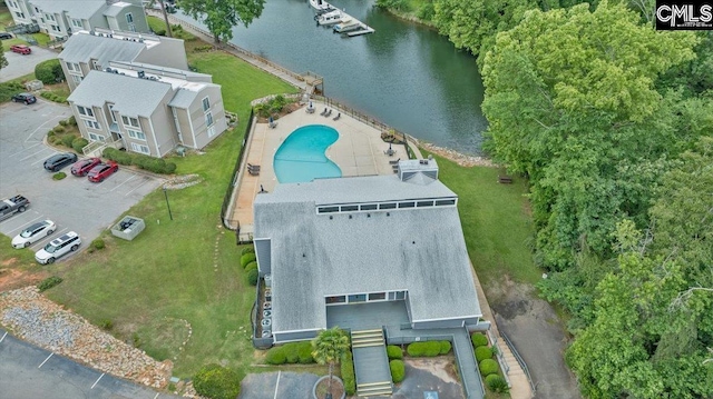 view of subject property with a large body of water and a pool area