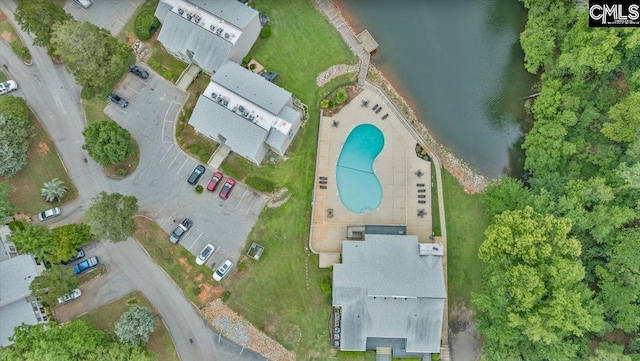 aerial overview of property's location with a nearby body of water and a pool area