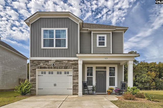 165 Wahoo Cir, Irmo, SC 29063 - view of front facade with stone siding, an attached garage, concrete driveway, covered porch, and board and batten siding