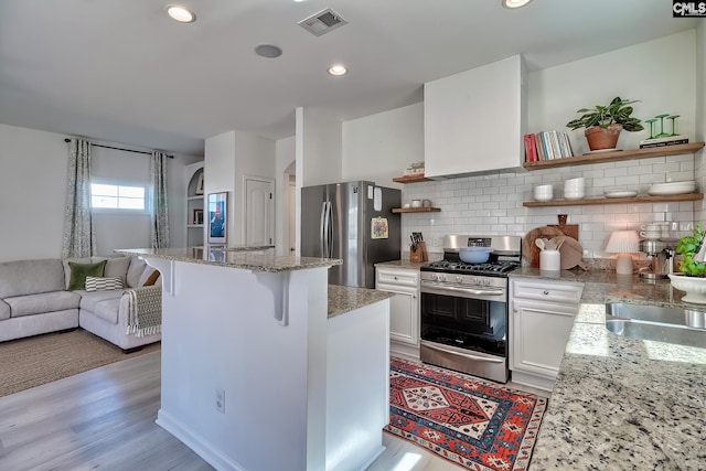 165 Wahoo Cir, Irmo, SC 29063 - kitchen featuring stainless steel appliances, open shelves, white cabinetry, a kitchen island, and decorative backsplash