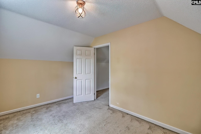 bonus room with lofted ceiling, carpet, baseboards, and a textured ceiling
