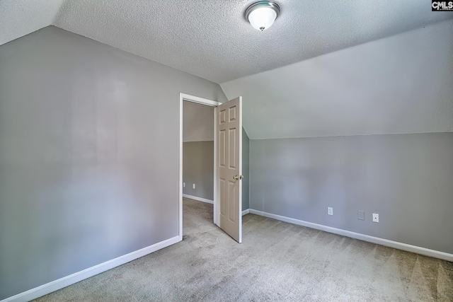 bonus room featuring vaulted ceiling, carpet flooring, baseboards, and a textured ceiling