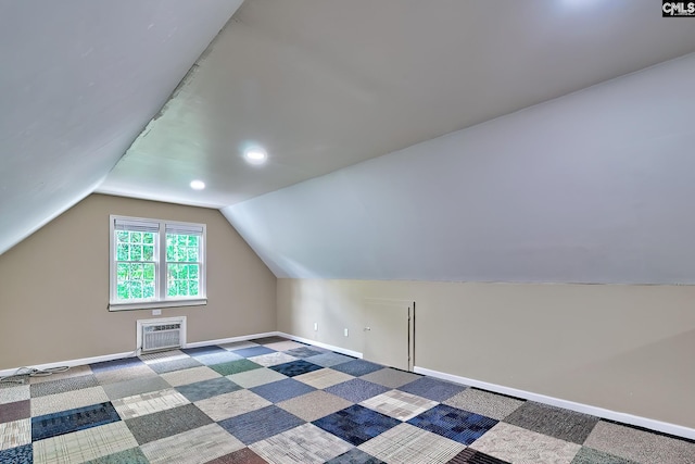 additional living space featuring lofted ceiling, an AC wall unit, baseboards, carpet, and recessed lighting