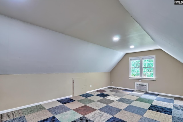 bonus room with lofted ceiling, carpet floors, baseboards, a wall mounted AC, and recessed lighting