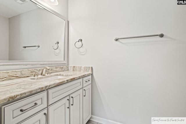 bathroom with vanity and baseboards