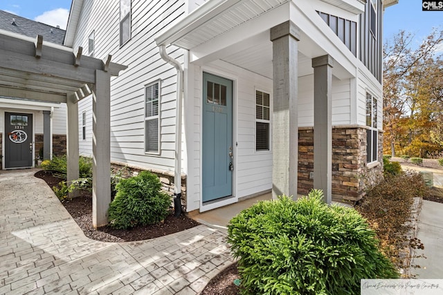 doorway to property with stone siding