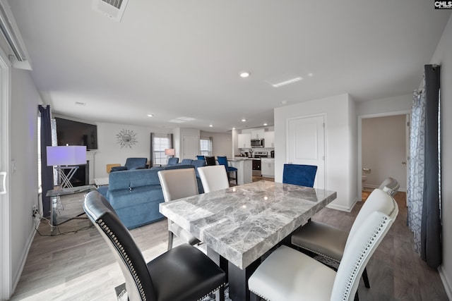 2109 Elmridge Rd, Columbia, SC 29209 - dining space featuring baseboards, light wood-style floors, and recessed lighting