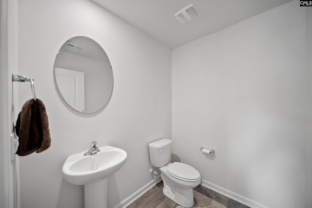 2109 Elmridge Rd, Columbia, SC 29209 - bathroom with toilet, wood finished floors, baseboards, and a sink