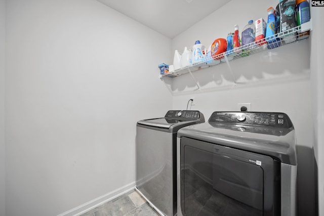 2109 Elmridge Rd, Columbia, SC 29209 - laundry area featuring washing machine and dryer, baseboards, and stone finish flooring