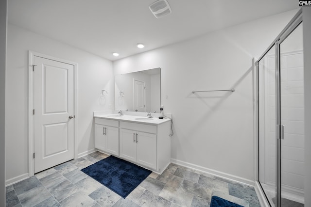 2109 Elmridge Rd, Columbia, SC 29209 - full bathroom with baseboards, a stall shower, stone finish flooring, double vanity, and recessed lighting