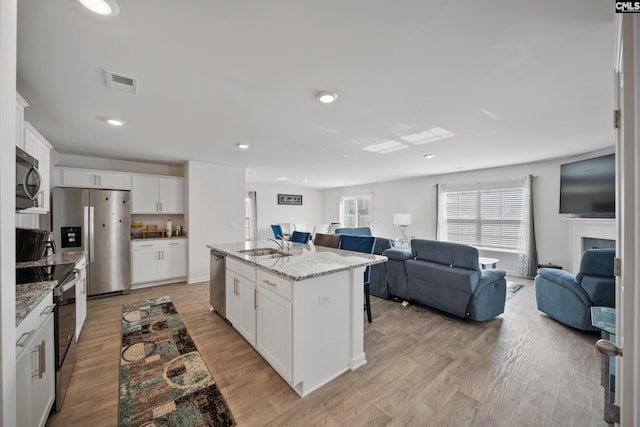 2109 Elmridge Rd, Columbia, SC 29209 - kitchen featuring appliances with stainless steel finishes, open floor plan, light wood finished floors, a sink, and recessed lighting