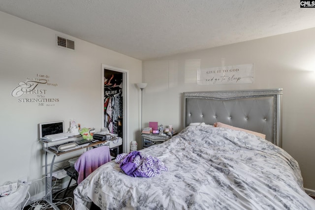 1302 Old Manor Rd, Columbia, SC 29210 - bedroom featuring a spacious closet, a textured ceiling, and a closet