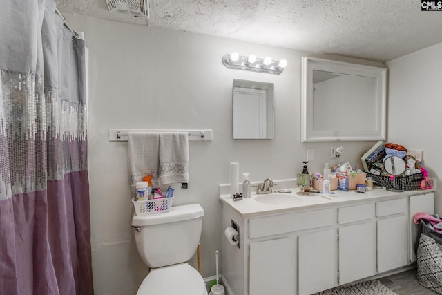 1302 Old Manor Rd, Columbia, SC 29210 - bathroom featuring a textured ceiling, toilet, vanity, and curtained shower