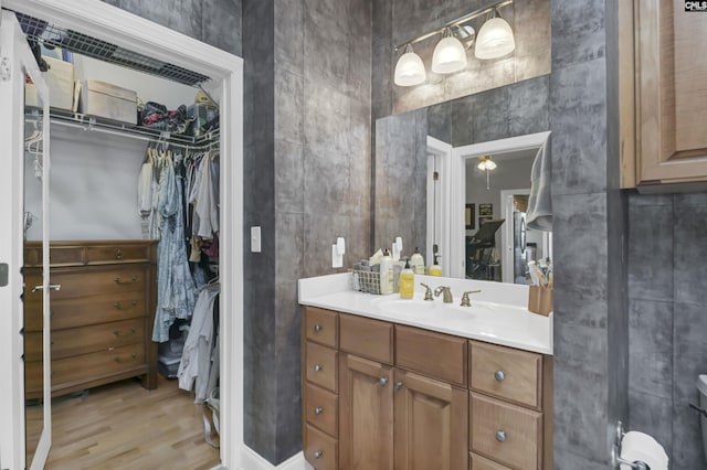 1320 Pulaski St Unit B207, Columbia, SC 29201 - bathroom with wood finished floors, a walk in closet, and vanity