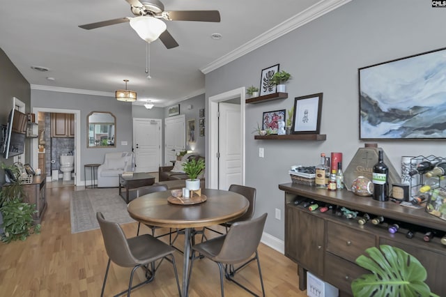 1320 Pulaski St Unit B207, Columbia, SC 29201 - dining space featuring ceiling fan, light wood-style floors, baseboards, and crown molding