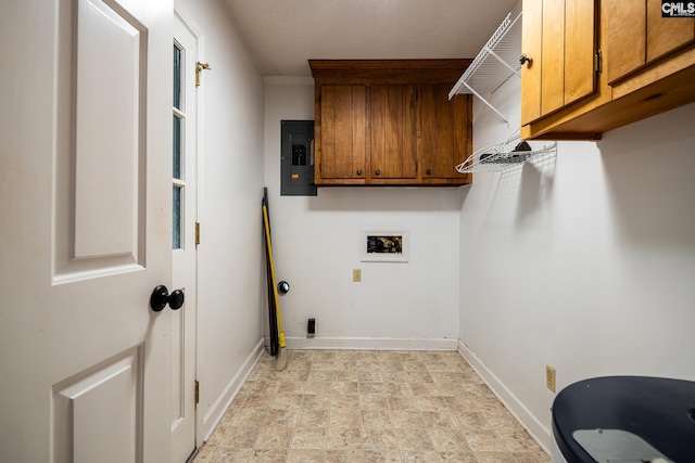 washroom featuring electric panel, cabinet space, washer hookup, and baseboards