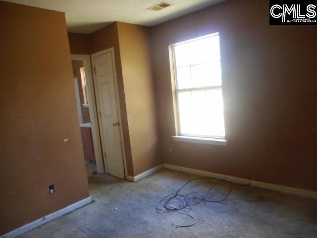 2133 Slighs Ave, Columbia, SC 29204 - unfurnished bedroom featuring multiple windows, carpet, and baseboards