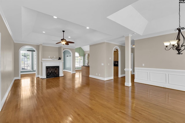 22 Mauser Dr, Lugoff, SC 29078 - unfurnished living room with arched walkways, a tray ceiling, ornamental molding, a ceiling fan, and light wood finished floors