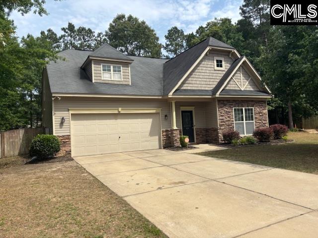 404 Coopers Edge Ln, Blythewood, SC 29016 - craftsman house featuring stone siding, a garage, fence, and concrete driveway