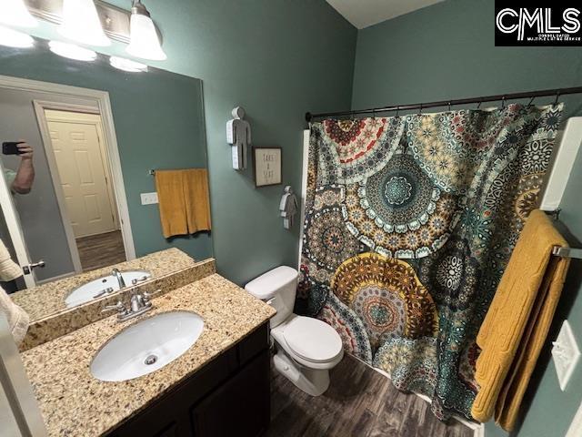404 Coopers Edge Ln, Blythewood, SC 29016 - full bath with wood finished floors, vanity, toilet, and a shower with shower curtain