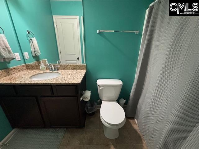 404 Coopers Edge Ln, Blythewood, SC 29016 - full bathroom featuring toilet, vanity, tile patterned flooring, and a shower with curtain
