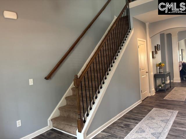 404 Coopers Edge Ln, Blythewood, SC 29016 - stairs with arched walkways, wood finished floors, and baseboards
