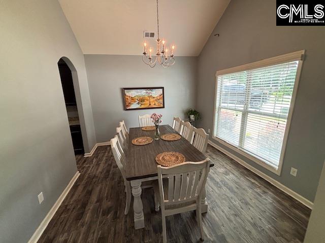 404 Coopers Edge Ln, Blythewood, SC 29016 - dining area with arched walkways, baseboards, wood finished floors, a chandelier, and high vaulted ceiling