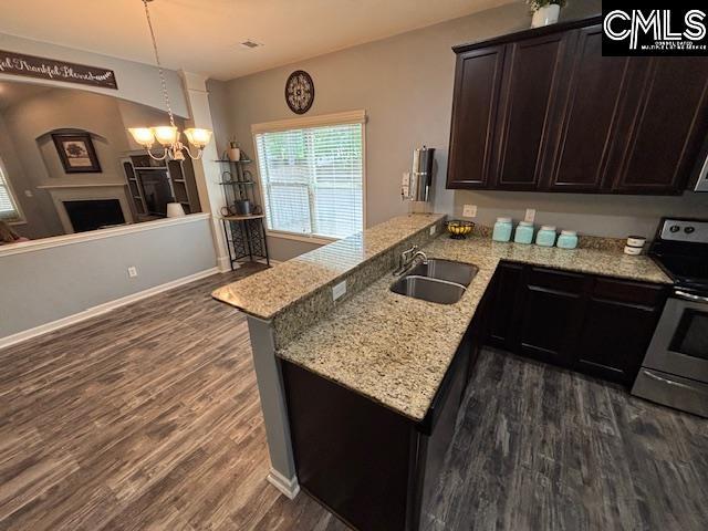 404 Coopers Edge Ln, Blythewood, SC 29016 - kitchen featuring a sink, electric range, dark wood-style flooring, a chandelier, and dark brown cabinets